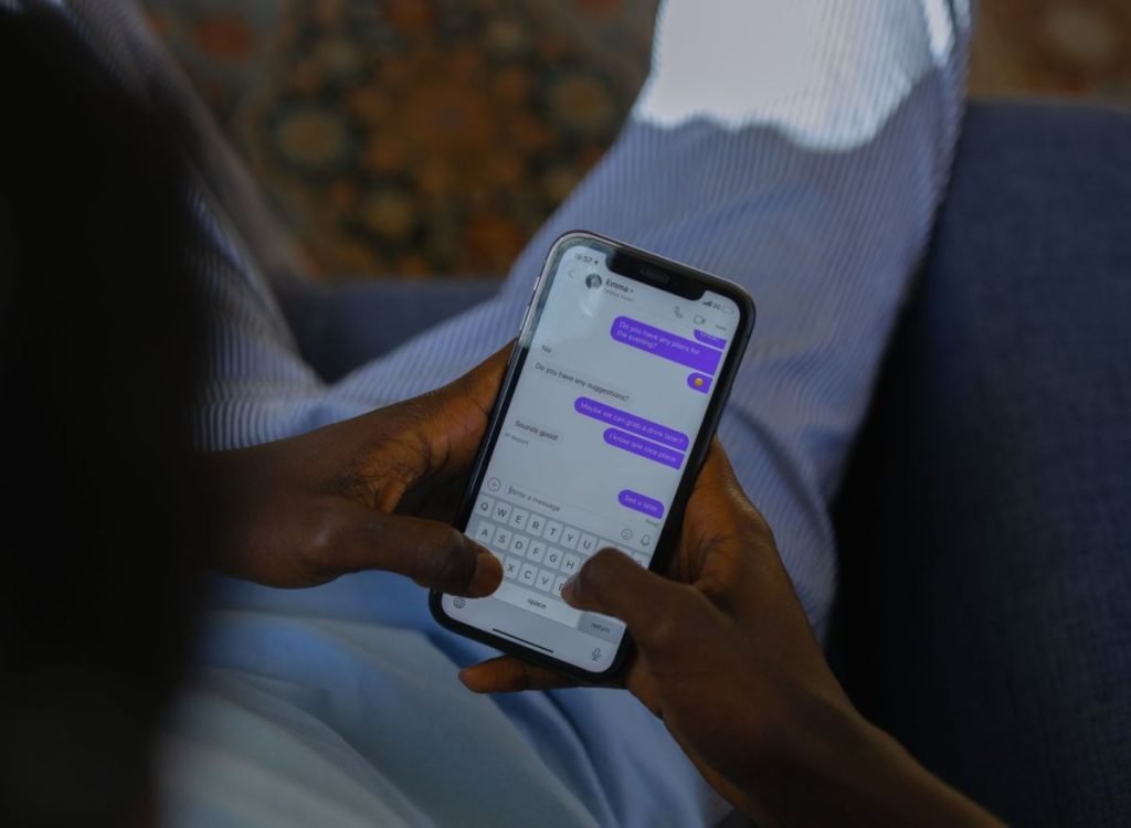 Customer chatting with a brand on WhatsApp on a smartphone